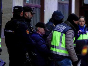 Spanish national police officers lead away a 74-year-old man under arrest on suspicion of being the sender of letter-bombs in November and December to the Ukrainian and U.S. embassies and several institutions in Spain, in Miranda de Ebro, Spain January 25, 2023.