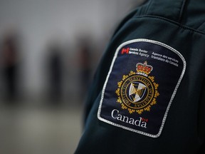 A patch is seen on the shoulder of a Canada Border Services Agency officer's uniform in Tsawwassen, B.C., Friday, Dec. 16, 2022. The Canada Border Services Agency says there are alternatives to holding immigration detainees in provincial jails after Alberta said it would no longer agree to do so.