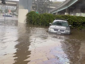 Cars are seen partially submerged on a flooded road after heavy rains in San Francisco, California, U.S., December 31, 2022, in this screengrab obtained from a social media video.