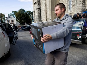 TUPOC director William Komer packs up to leave the former St. Brigid's church after a court ruling upheld the group's eviction from the building last September.