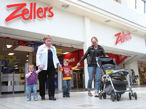 Shoppers walk past the Zellers store at the Woodbine Centre in Etobicoke on May 26, 2011.