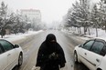 An Afghan woman begs on a snowy day in Kabul, Jan. 29. While millions of Afghans face hunger, the Taliban leadership are focused on reviving their theocratic dystopia of the 1990s.