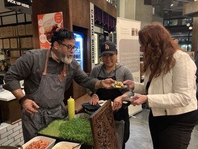 Thali's Joe Thottungal, left, and Alizé Chen, serve up a lamb dish at the launch of the SoPa (South of Parliament) area of downtown.