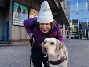 Kim Kilpatrick and her guide dog Ginger pose for a photo outside Lunchbox Theatre on Wednesday.