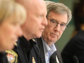 File photo: Ottawa Mayor, Jim Watson listens to Interim Ottawa Police Chief Steve Bell talk to the media about the preparation plan for this weekend's convoy in Ottawa, April 28, 2022.