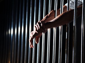 close up of hand in jail background.