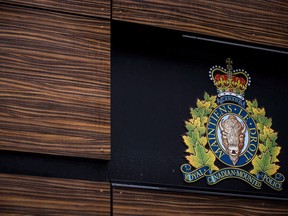 The RCMP logo is seen outside Royal Canadian Mounted Police "E" Division Headquarters, in Surrey, B.C., on Friday April 13, 2018. Two RCMP officers have been accused of manslaughter over the death of an Indigenous man in British Columbia, while three of their fellow Mounties are charged with attempting to obstruct justice.