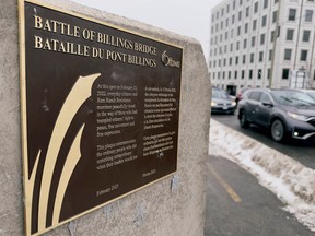 A plaque commemorating the 'Battle of Billings Bridge' during the  2022 convoy protests erected at a bridge over the Rideau River.