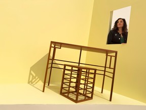 Curator Sonia Del Re within a sculpture by Toronto based artist Paul P. titled Escritoire Nancy-2013, in mahogany, that is part of the exhibition Paul P. : Amor et Mors at the National Gallery of Canada.