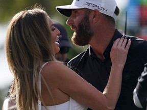 Dustin Johnson embraces his wife Paulina Gretzky after winning the team championship in the season finale of the LIV Golf series at Trump National Doral in October.