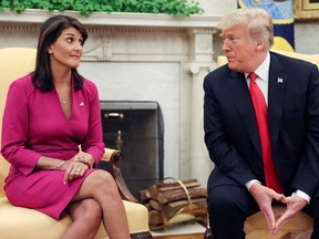 Then-U.S. President Donald Trump talks with Nikki Haley in the White House after it was announced Trump had accepted Haley's resignation as UN ambassador, October 9, 2018.