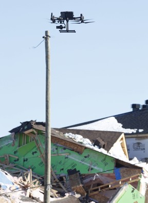 Penyelidik menggunakan drone di tempat kejadian Selasa pagi.