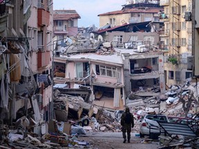 A Turkish soldier walks among destroyed buildings in Hatay, on Feb. 12.