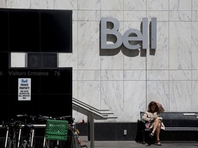A women reads outside a Bell Canada office in Toronto, Ontario, Canada, on Wednesday, June 22, 2016.