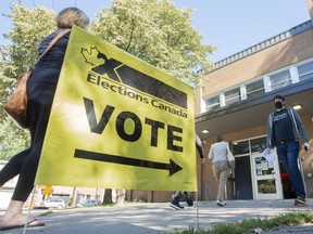 People arrive to cast their ballot on federal election day in Montreal, Monday, Sept. 20, 2021. A Parliamentary committee is set to decide whether or not it will expand its current study on foreign election interference to include more details about the 2021 federal election.