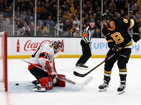 Boston Bruins right wing David Pastrnak (88) slips the puck between the legs of Ottawa Senators goaltender Kevin Mandolese (70) for a goal during the third period at TD Garden.