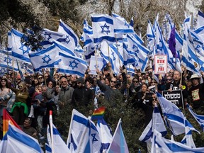 Protesters attend a massive demonstration infront of the Israeli parliament as opposition leadears call for a nationwide strike and protests all over the country against the Israeli government on February 13, 2023 in Jerusalem, Israel. Israel's Knesset may begin the legislation process of the judicial overhaul, that will increase the government's sway in selecting judges while weakening Supreme Court power to strike down laws.