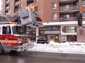 Ottawa Fire Services personnel on the scene at Les Suites Hotel in downtown Ottawa on Saturday afternoon.