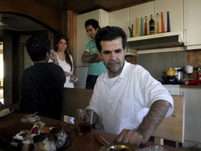 FILE - Iranian filmmaker Jafar Panahi is shown at his home after he was freed from jail on bail after more than two months in custody, in Tehran, Iran, on May 25, 2010. Panahi who was arrested last summer, weeks before his latest film was released to widespread acclaim, has gone on hunger strike to protest his continued detention amid more than four months of anti-government protests.