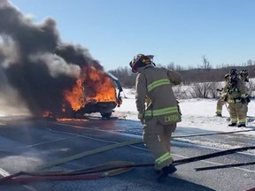 Ottawa firefighters battle a vehicle fire on Highway 416 on Saturday, Feb. 11, 2023.