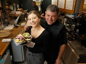Luis Granati (right) and his daughter Isabella pose for a photo at their restaurant Gooney's Arepas and Sandwich Works at 360 Laurier Ave W in Ottawa Thursday afternoon.