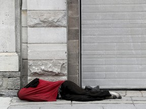 Down and out in the ByWard Market: a homeless man sleeps on a city street in Lowertown.