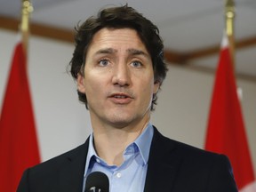 Prime Minister Justin Trudeau speaks to the media Sunday, February 12, 2023, in Ottawa before boarding a flight to the Yukon after ordering the take down of an unidentified object that violated Canadian airspace.