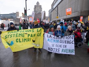 People take part in a climate change protest, in Montreal on Friday, Feb. 24, 2023.