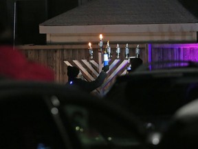 A menorah is lit by an Ottawa rabbi, in this 2020 file photo. Antisemitism, including bigoted humour, is on the rise in Canada, says Ben Dodek.