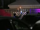 A menorah is lit by an Ottawa rabbi, in this 2020 file photo.  Antisemitism, including bigoted humor, is on the rise in Canada, says Ben Dodek.