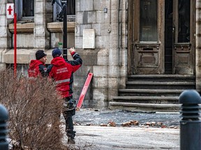 Firefighters continue their investigation at a building in Old Montreal ravaged by fire last week. At least five people are still missing.