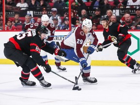 Nathan MacKinnon of the Colorado Avalanche skates with the puck past Jake Sanderson of the Ottawa Senators during the first period at Canadian Tire Centre on Thursday.