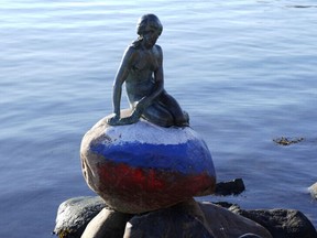 A statue of 'The Little Mermaid' is seen, created by the sculptor Edvard Eriksen and modeled after his wife, Eline, with the Russian flag painted on the stone she sits on, in what police said was a "case of vandalism", in Langelinie, Copenhagen, Denmark March 2, 2023.