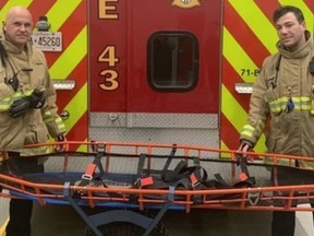 Ottawa firefighters with a Stokes basket with an all-terrain wheel attached to it.