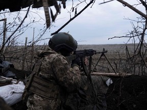 A soldier of the Ukrainian Volunteer Army fires at Russian front line positions near Bakhmut, Donetsk region, on March 11, 2023, amid the Russian invasion of Ukraine.
