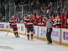 Pavel Mintyukov (4) celebrates with teammates after scoring a second-period goal for the Ottawa 67's against the Barrie Colts in an Ontario Hockey League game at Ottawa's TD Place arena on Saturday, March 25, 2023. The 67's won the game 5-1.