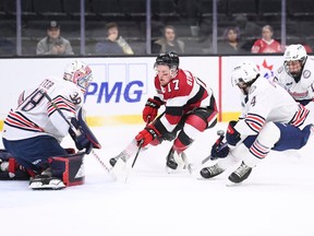 GATINEAU, March 30, 2023: Brady Stonehouse (17) of the Ottawa 67's drives toward the net of Oshawa Generals goaltender Jacob Oster in front of defencemen Luca D'Amato (4) and Ryan O'Dell (15) during the first period of an Ontario Hockey League playoff game at the Slush Puppie Centre in Gatineau, Que., on Thursday, March 30, 2023. The game was in Gatineau because the 67's home rink in Ottawa was being used for the men's world curling championship.