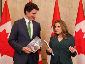 Prime Minister Justin Trudeau and Finance Minister Chrystia Freeland speak to the media, holding the 2023-24 budget, on Parliament Hill on March 28, 2023.