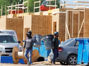 File photo: Construction workers work on new homes in Ottawa, Ontario, Canada, May 27, 2021.
