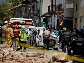 A damaged car and rubble from a house affected by the earthquake are pictured in Cuenca, Ecuador. March 18, 2023.