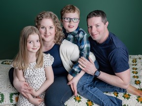 Kerry Monaghan sits with her husband Patrick and her two children Jack and Charlotte. The children have autism and Patrick is an advocate for people with autism in Ontario.