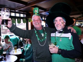 A photo taken Friday shows George Meranger, left, and Robin Blair in a festive atmosphere at the Heart and Crown in ByWard Market.