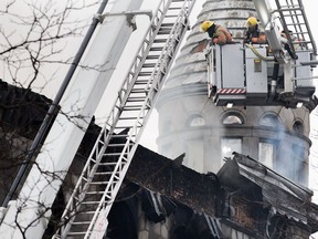 Firefighters survey the scene of a fire in Old Montreal, Thursday, March 16, 2023. Residents have been evacuated and multiple people have been treated for injuries.
