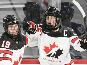 Marie-Philip Poulin (29) of Canada celebrates with teammate Brianne Jenner (19) after scoring against the USA during second period Rivalry Series hockey action in Laval, Que., Wednesday, February 22, 2023. Poulin will lead an experienced squad when Canada seeks its third straight women's world hockey title next month.