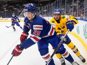 Defenceman Tyler Kleven tries to fend off the forechecking pressure of Fabian Lysell, right, during a world junior hockey championship game between the United States and Sweden at Edmonton in August.