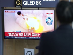 People watches a TV screen reporting North Korea's missile launch with file image during a news program at the Seoul Railway Station in Seoul, South Korea, Wednesday, March 22, 2023. North Korea launched multiple cruise missiles toward the sea on Wednesday, South Korea's military said, three days after the North carried out what it called a simulated nuclear attack on South Korea. The letters read "North, launched multiple cruise missiles."