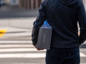 A person holding a Nordstrom Inc. shopping bag.