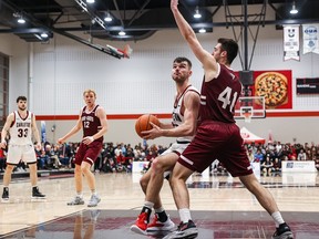 Guillaume Pépin of the Gee-Gees (41) defends Gebrael Semaha of the Ravens in the first half of Saturday's game.