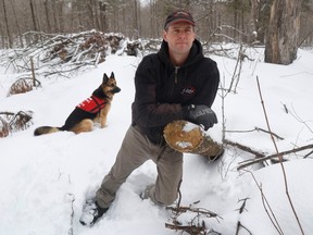 Scott Deugo, co-owner of Fulton's Sugar Bush poses with his dog Phoenix at his property. Fulton's   sugar bush operations were hit by the derecho last year, and Fulton's has bounced back, largely thanks to diversification of the business.