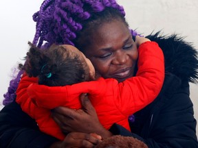 Gloria Luhaka hugs her daughter Hadly during a press conference in Ottawa last week. Her son Brantley (and twin to Hadly) died at CHEO.